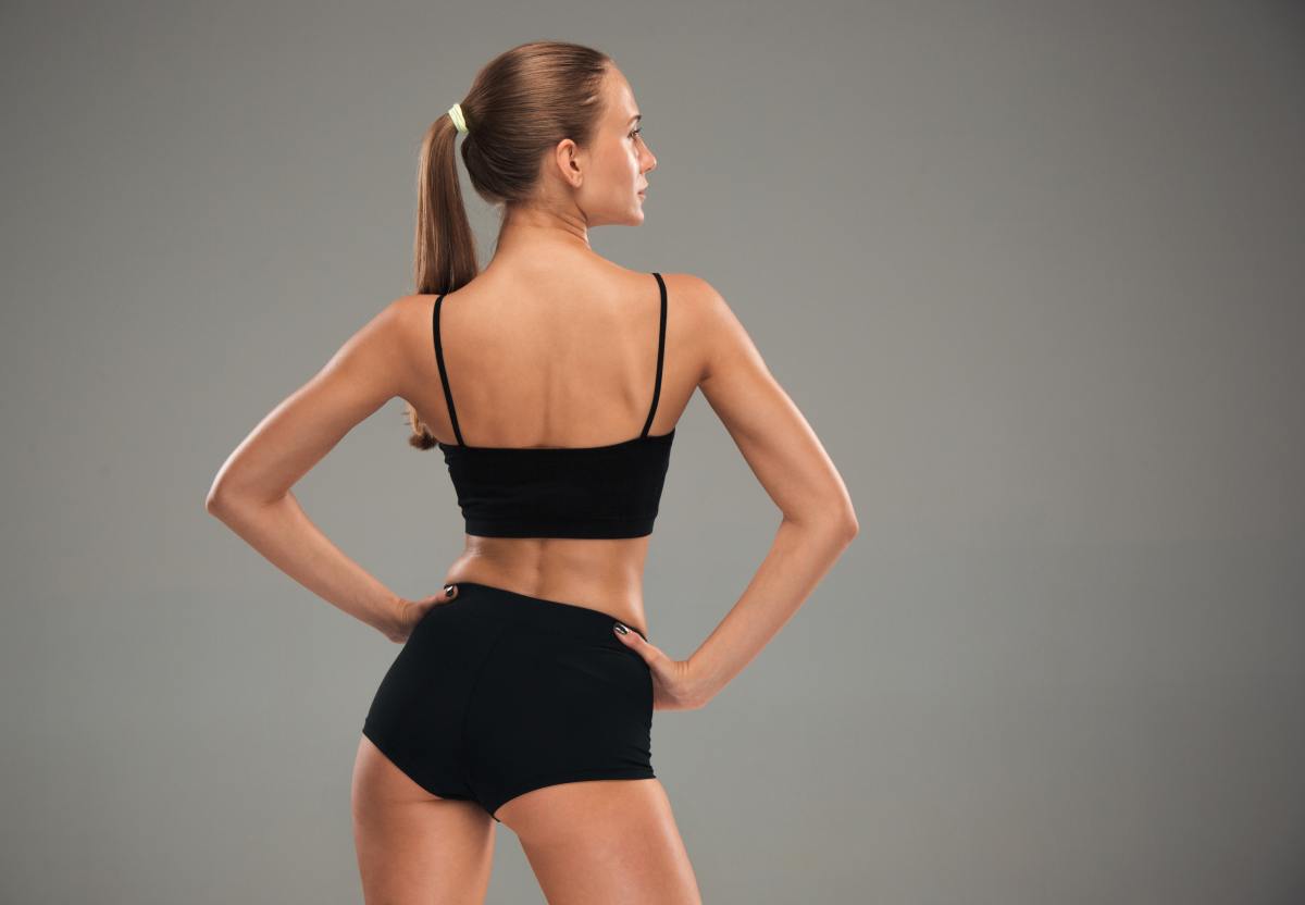 A plastic surgeon performing a butt lift, carefully injecting purified fat to enhance volume and shape naturally.